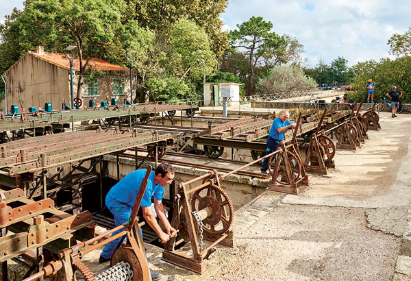 À son croisement avec le canal du Midi, lorsque le Libron entre en crue, huit bâches, telles d’énormes gouttières de métal coulissantes, sont mises en place pour lui permettre de passer par-dessus le canal. 